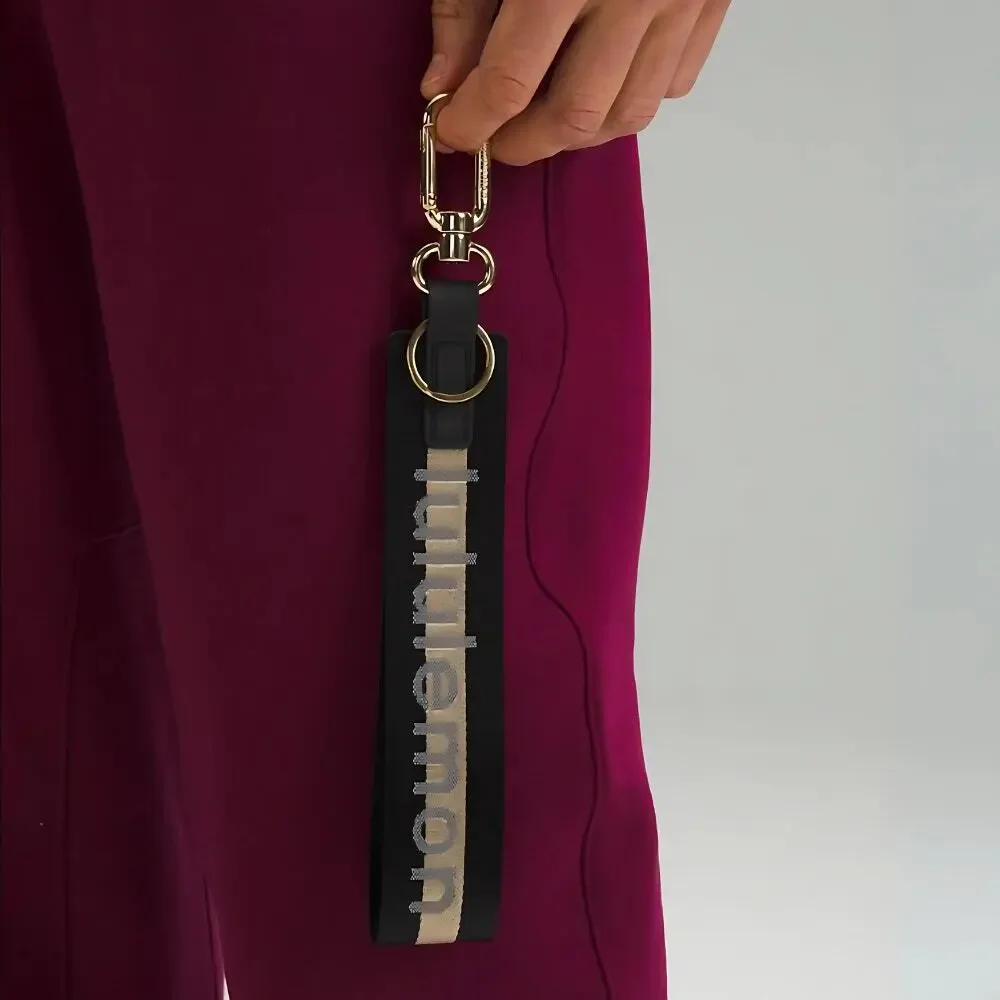 NEW Lululemon Never lost Keychain Wordmark Black and Gold